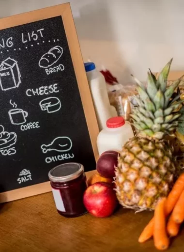 Grocery list on a blackboard and fresh produce