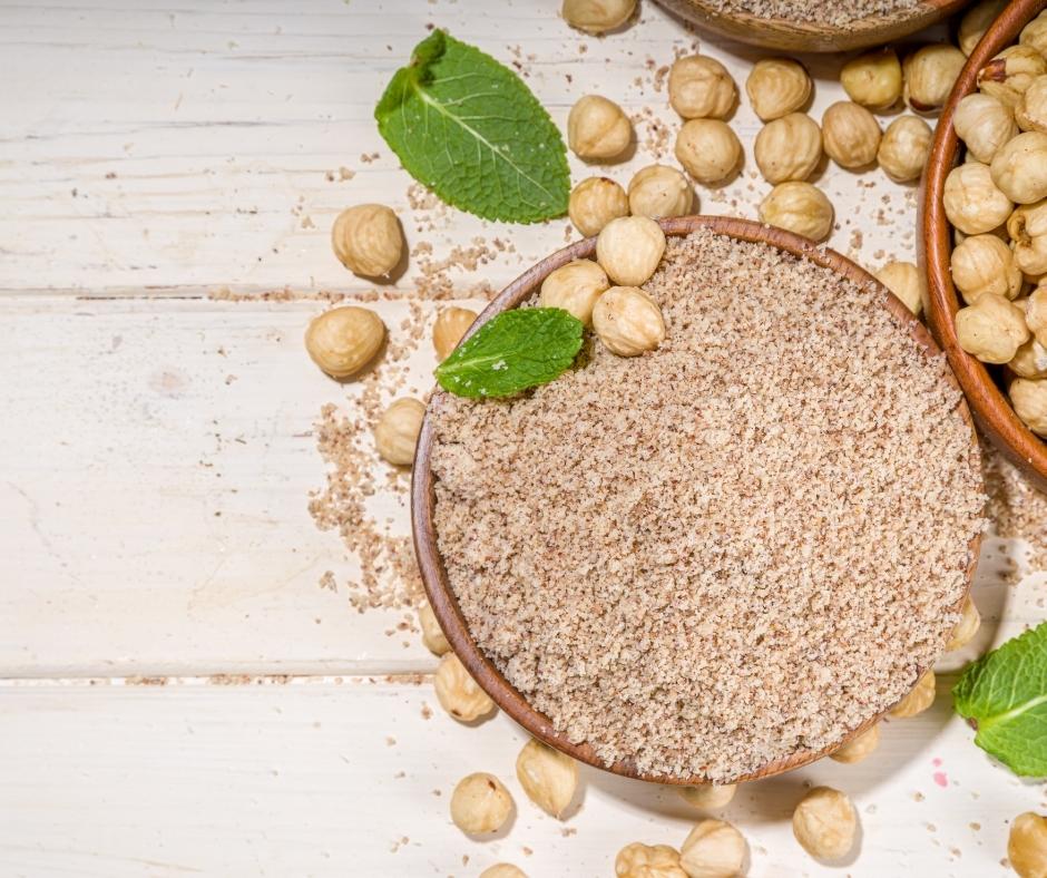 Hazelnut flour and hazelnuts in bowls