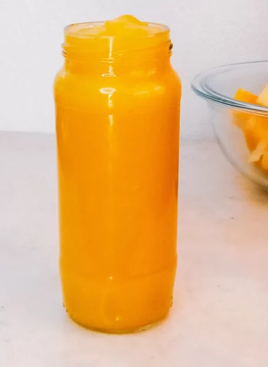 Homemade pumpkin puree in a jar and fresh diced pumpkin.