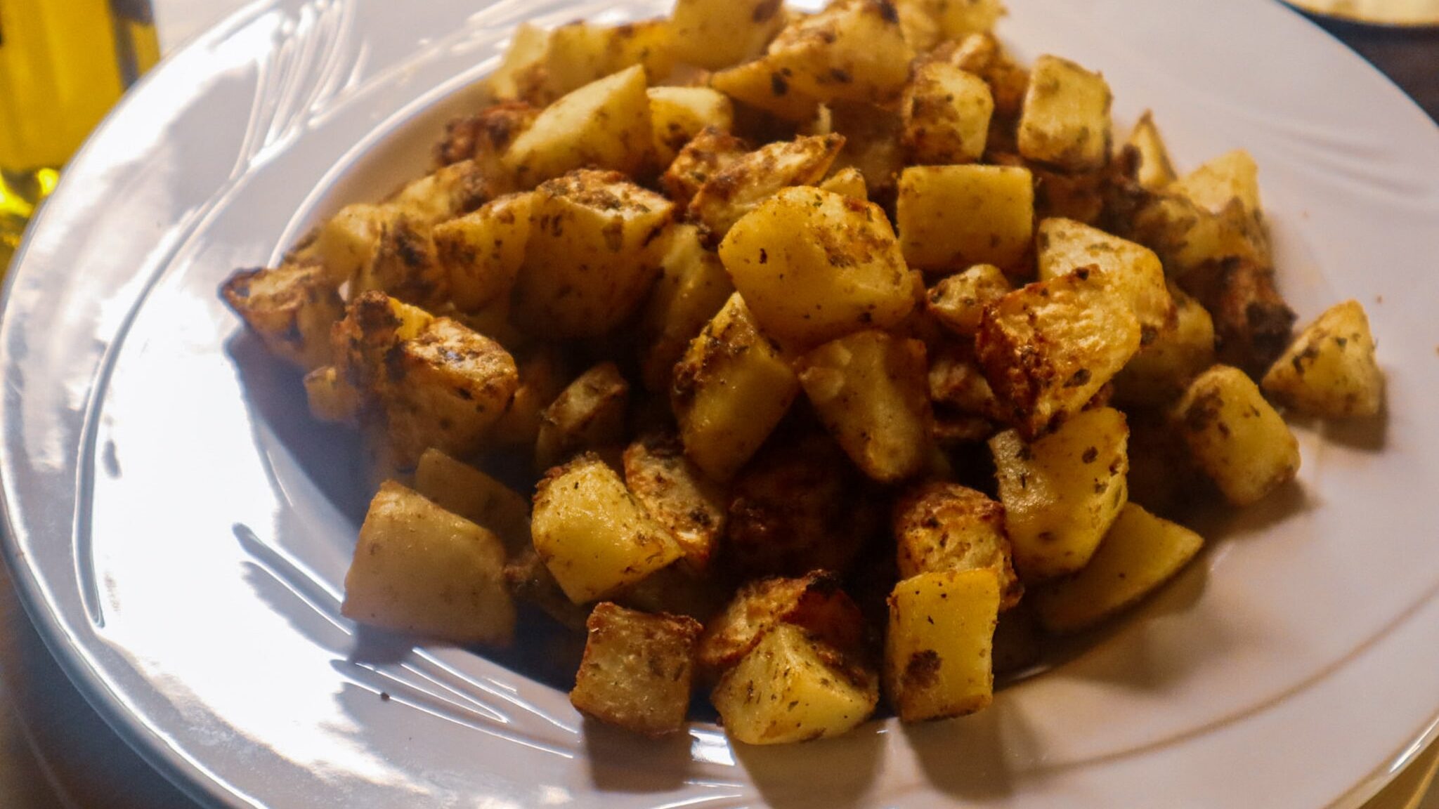 Air fryer garlic parmesan potatoes in a bowl.