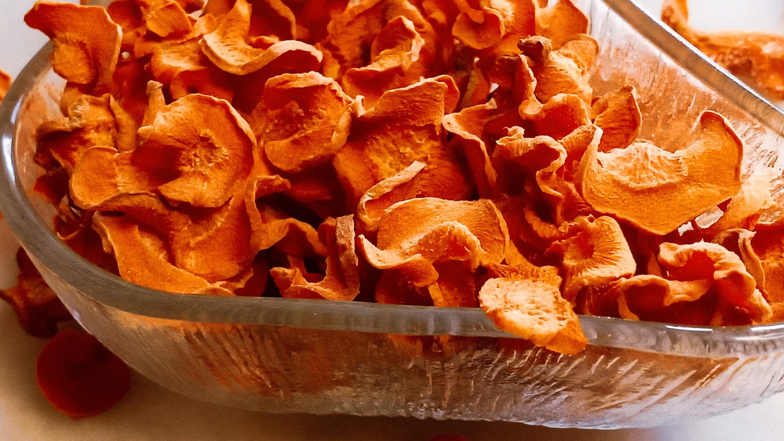 Dehydrated carrot chips in a bowl.