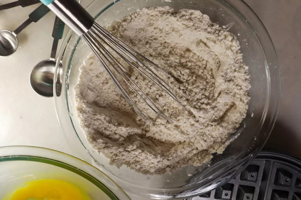 Dry ingredients being whisked in a bowl.