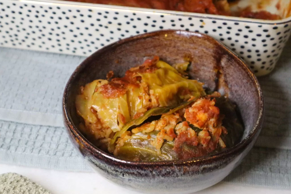 Seafood stuffed cabbage rolls in a bowl.