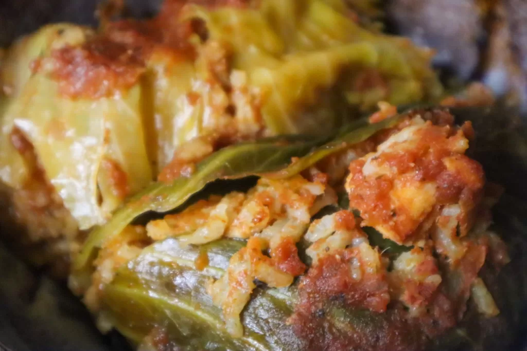 Seafood stuffed cabbage rolls in a bowl.