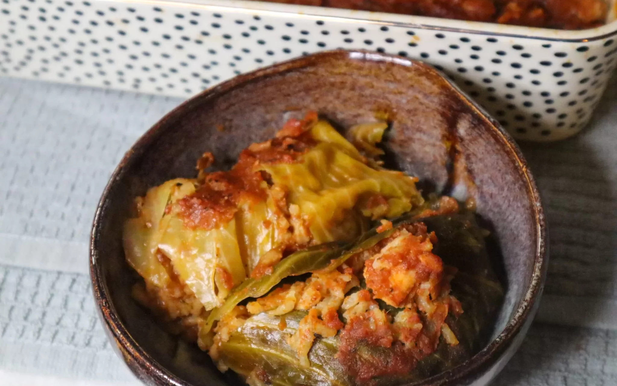 Seafood stuffed cabbage rolls in a bowl.
