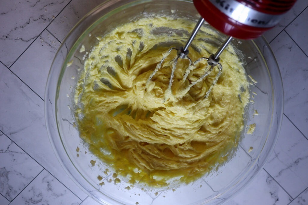 Adding the eggs and vanilla extract.