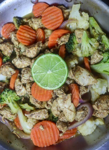 Zesty Chicken And Vegetable Skillet garnished with a lime slice.