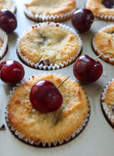 Keto Cherry Muffins garnished with fresh cherries.