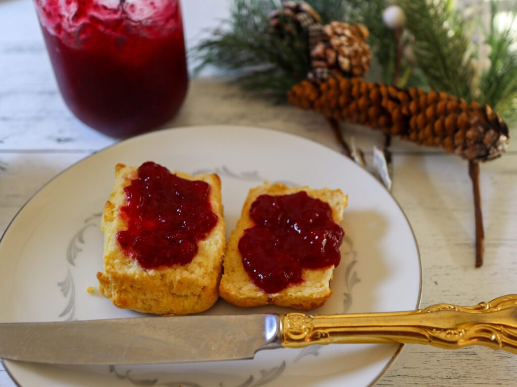 Cranberry jam spread on gluten-free biscuits.