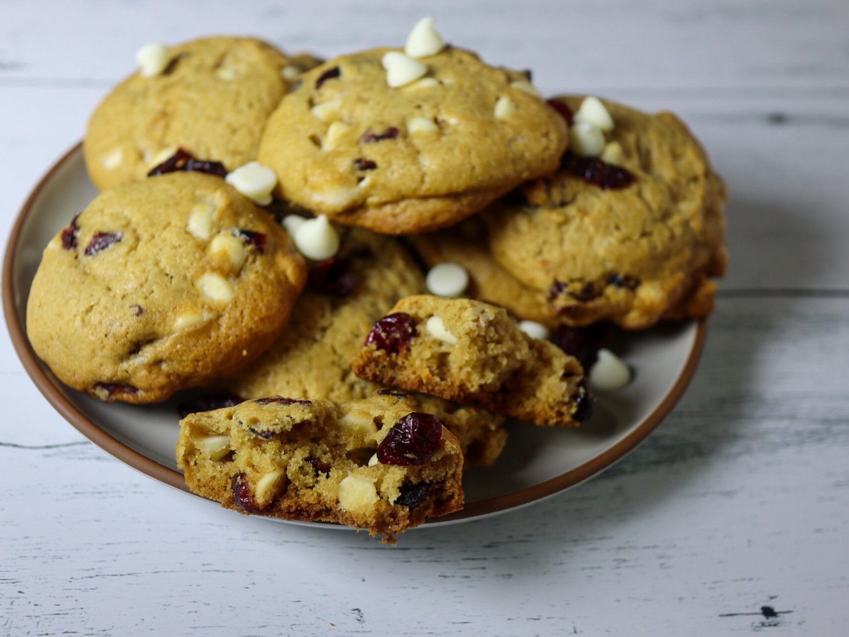 Gluten-free cranberry white chocolate chip cookies on on a plate.