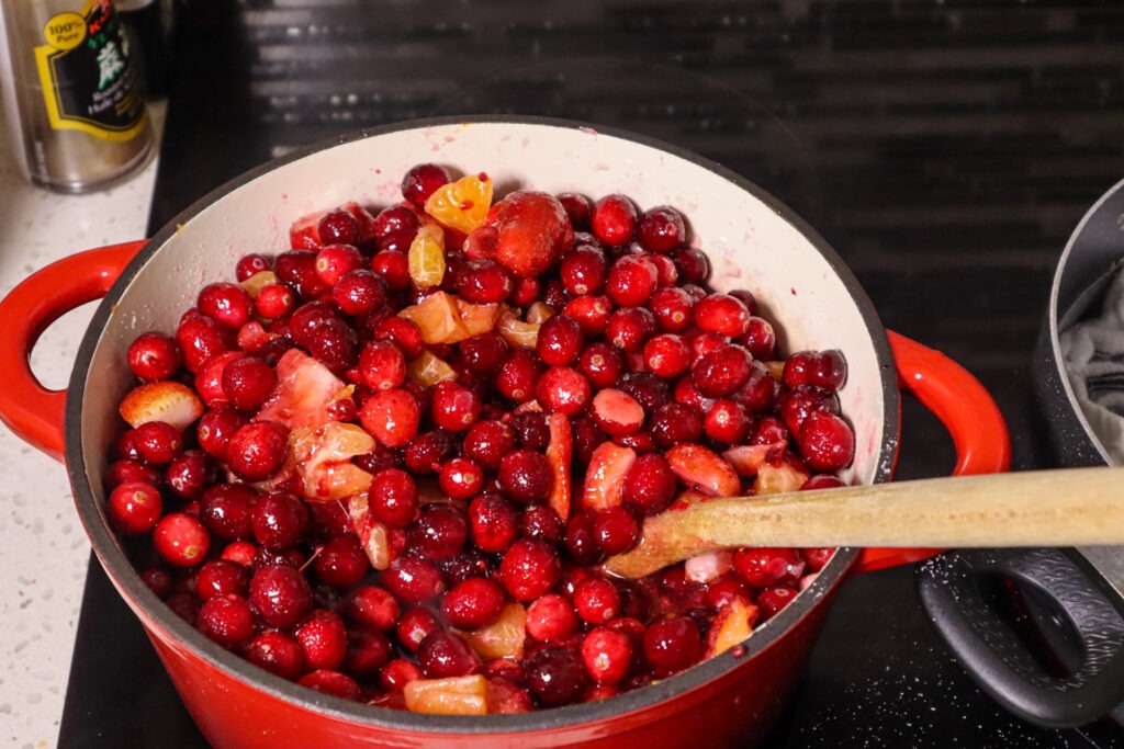 Mixing the strawberry cranberry jam ibgredients.