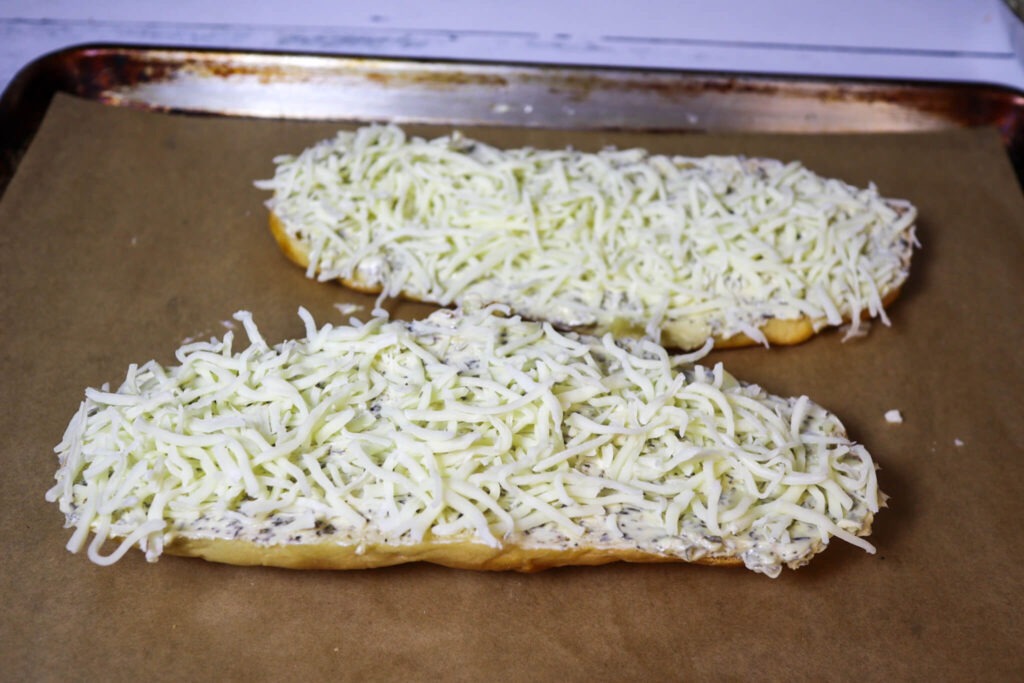 Sprinkling the cheese on top of the bread.