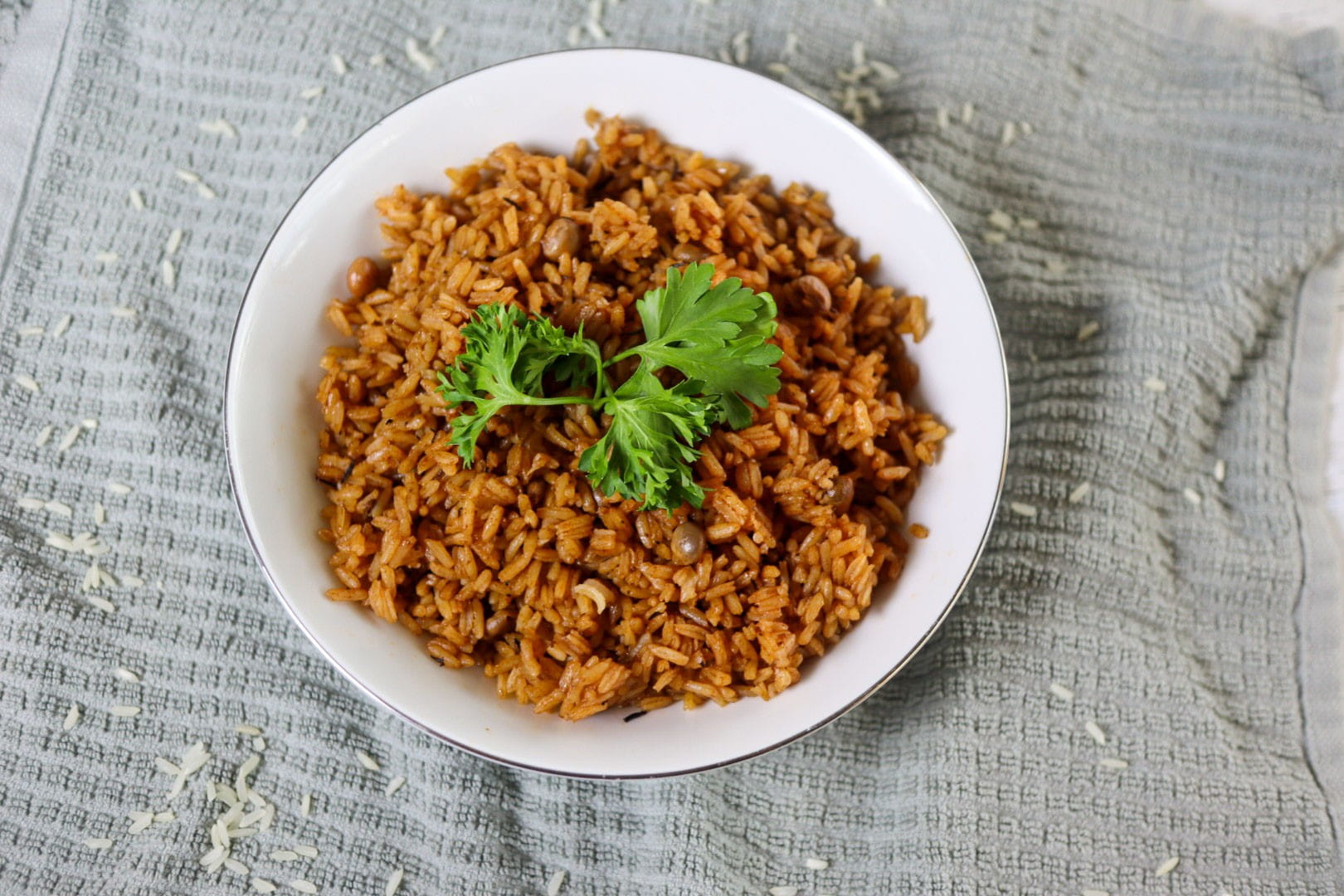 Bahamian peas and rice in a serving bowl garnished with parsley.